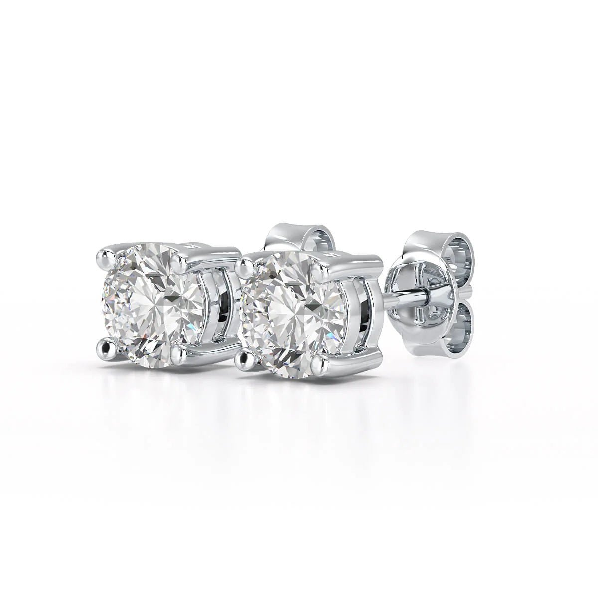 A pair of solitary diamond stud earrings. - ETERNA JEWELS