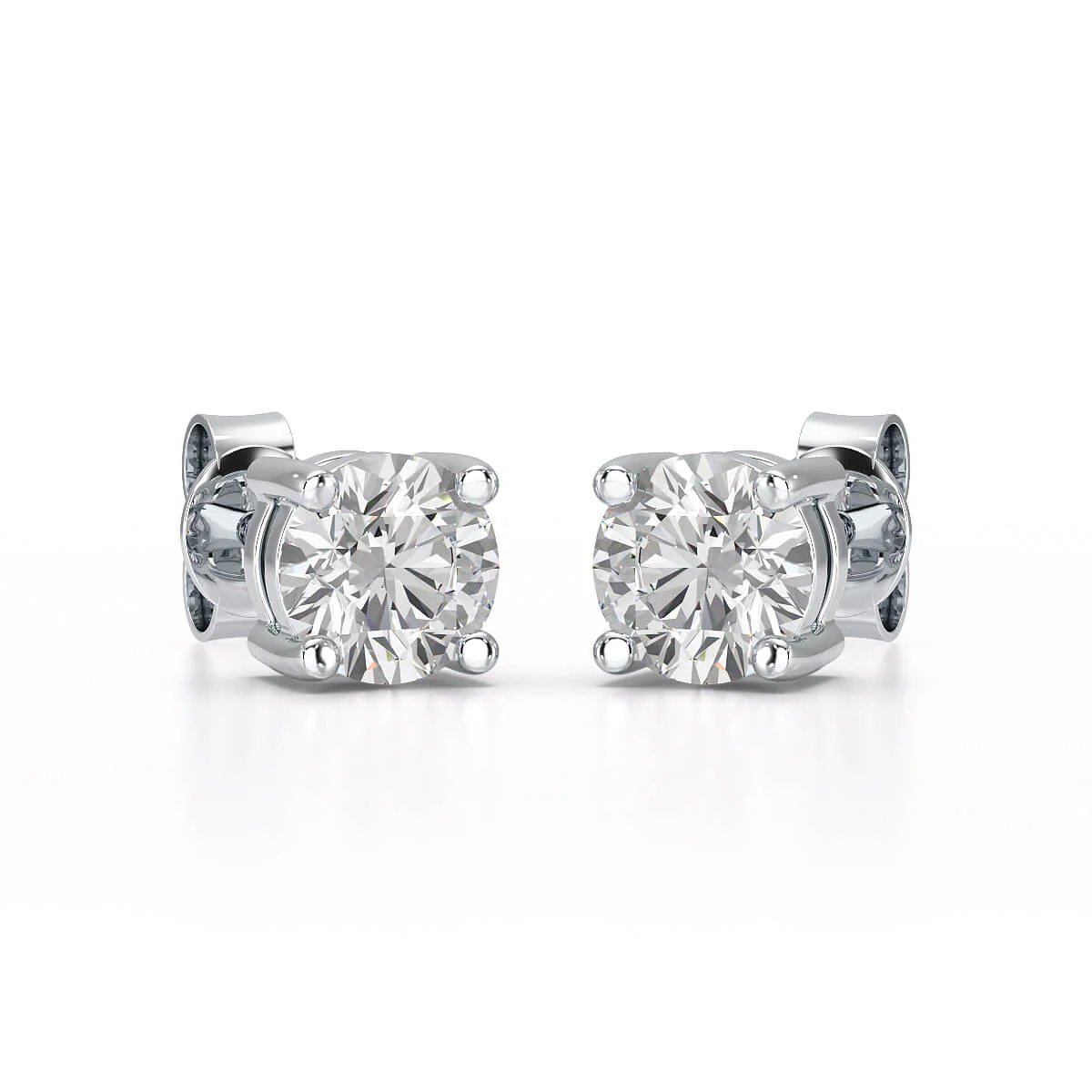 A pair of solitary diamond stud earrings. - ETERNA JEWELS