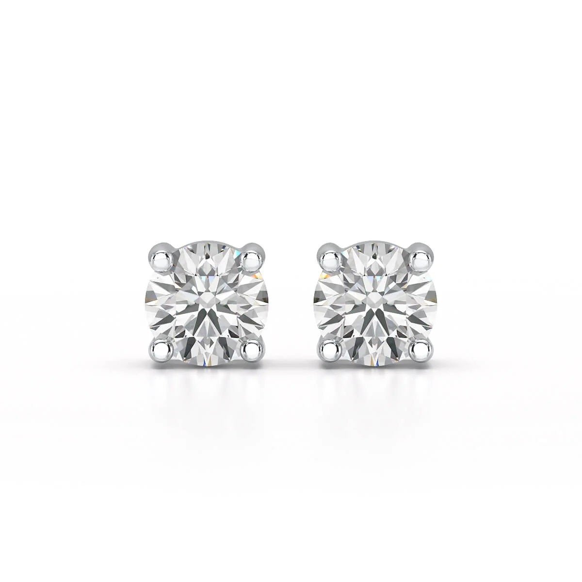 A pair of solitary diamond stud earrings. - ETERNA JEWELS